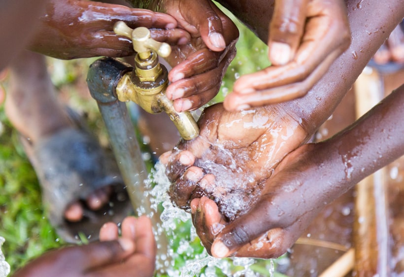 hands-being-washed-at-an-outdoor-tap-southern-africa-trust-1.jpg